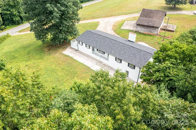 an aerial view of a house with a big yard