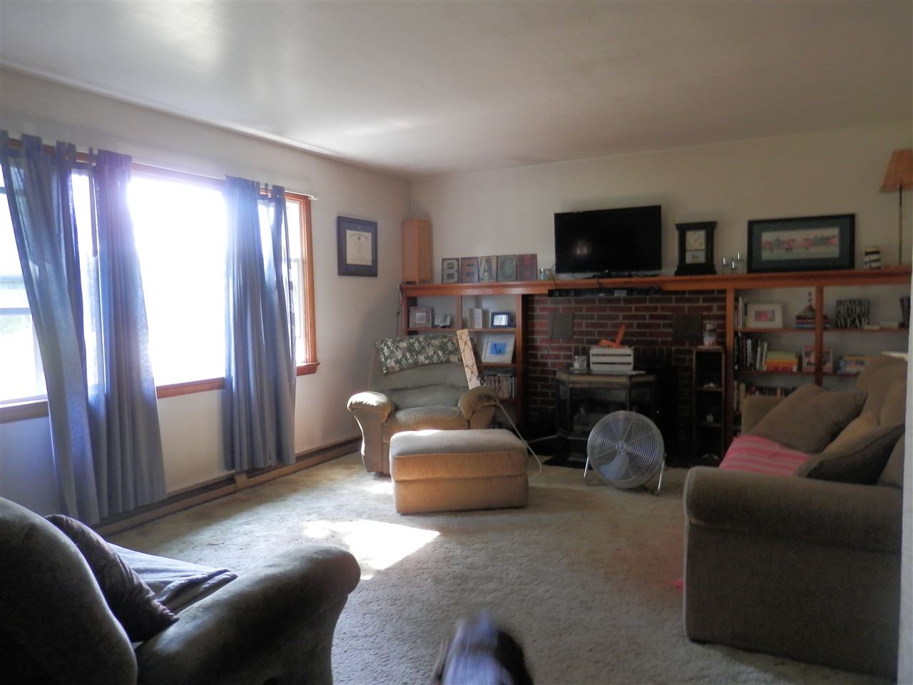 585 Rittenour Road Edinburg, VA 22824 - Photo 7 of 18 a living room with furniture a flat screen tv and a fireplace