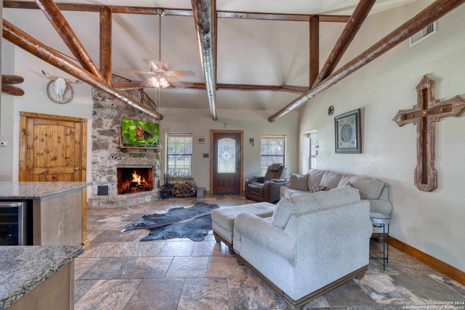 577 Mariposa Concan, TX 78838 - Photo 15 of 39 a living room with furniture a fireplace and a table