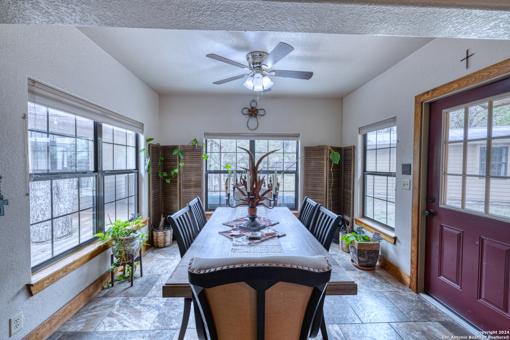 577 Mariposa Concan, TX 78838 - Photo 19 of 39 a view of a dining room with furniture a chandelier and large windows