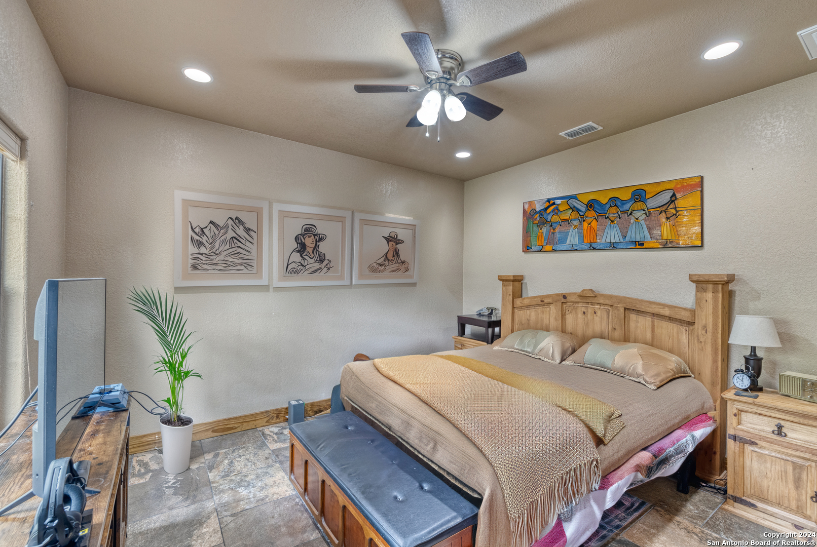 577 Mariposa Concan, TX 78838 - Photo 22 of 39 a bedroom with a bed and a chandelier