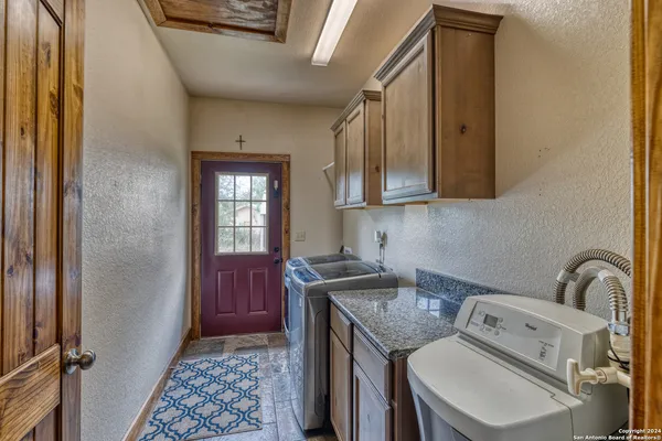 a kitchen with a sink stove and cabinets