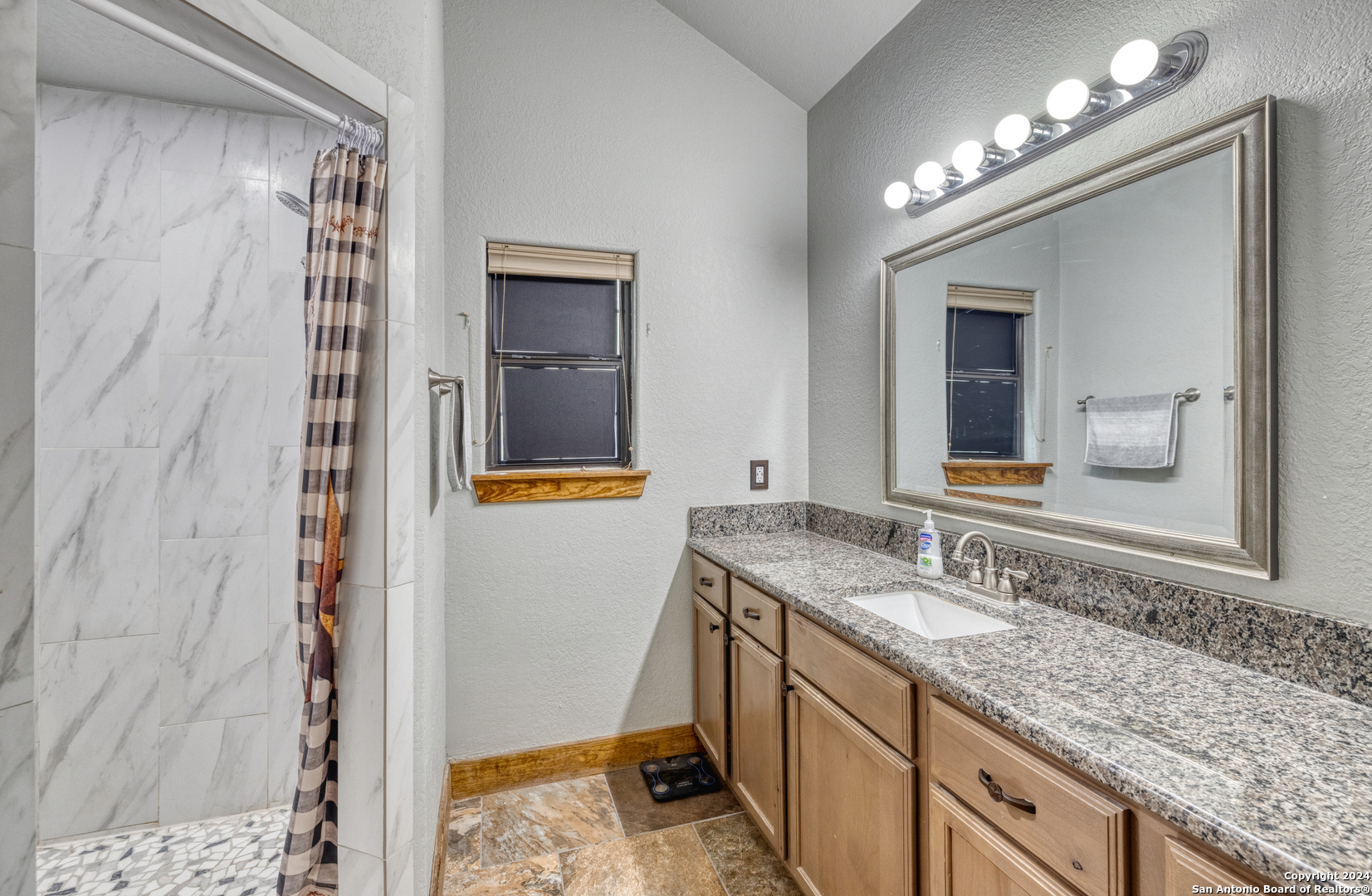577 Mariposa Concan, TX 78838 - Photo 27 of 39 a bathroom with a granite countertop sink and a mirror