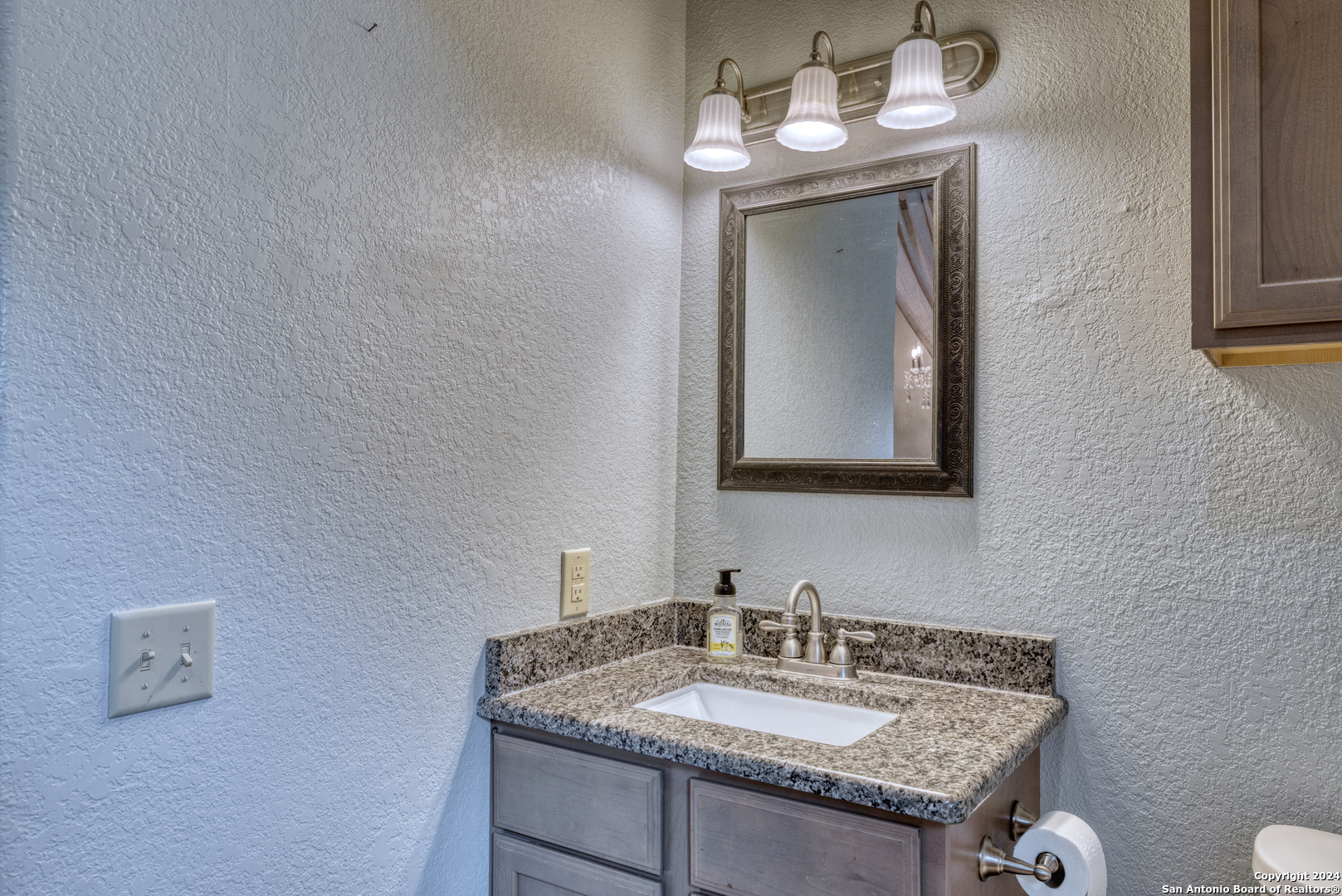 577 Mariposa Concan, TX 78838 - Photo 31 of 39 a bathroom with a granite countertop sink and a mirror