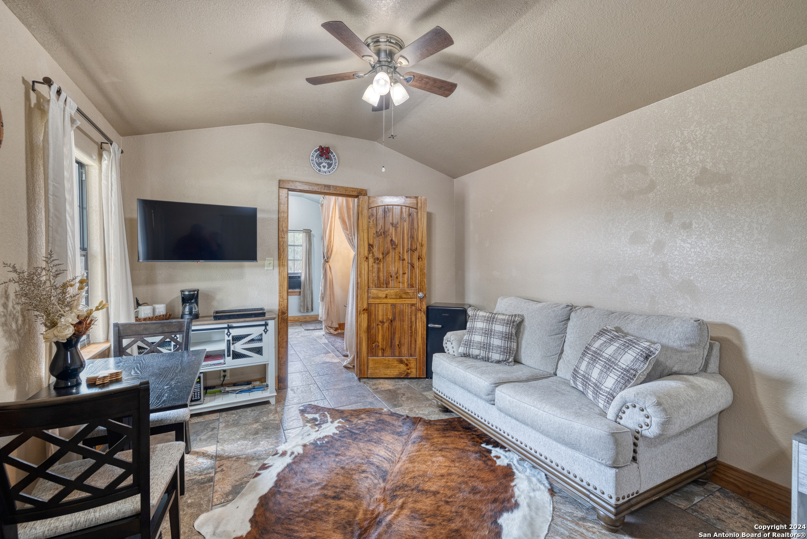 577 Mariposa Concan, TX 78838 - Photo 34 of 39 a living room with furniture and a flat screen tv