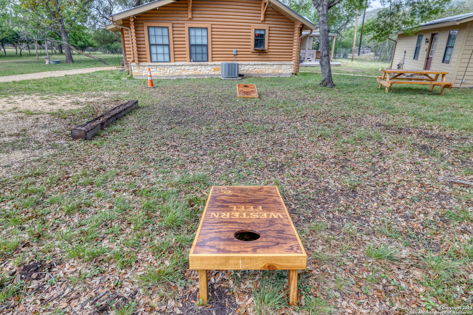 577 Mariposa Concan, TX 78838 - Photo 5 of 39 a backyard of a house with barbeque oven table and chairs