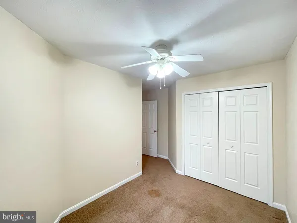 an empty room with a ceiling fan