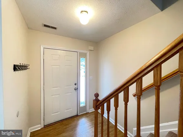 a view of an entryway with wooden floor