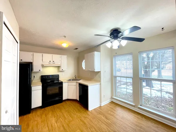 a kitchen with stainless steel appliances granite countertop a stove and a refrigerator