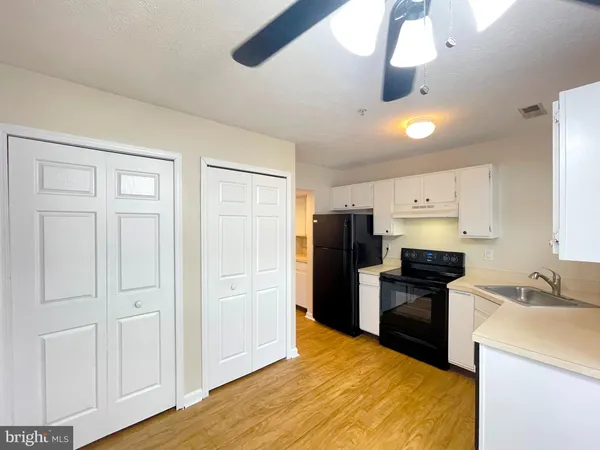 a kitchen with a refrigerator a stove and a sink