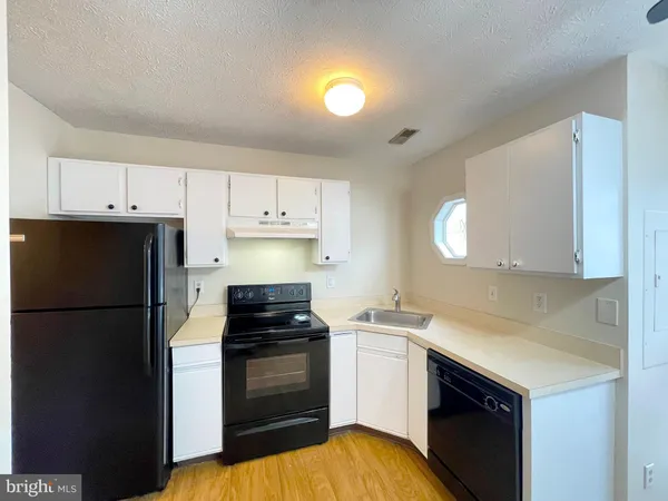 a kitchen with a sink and a refrigerator