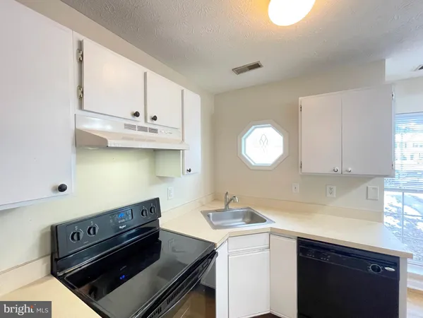 a kitchen with cabinets and appliances