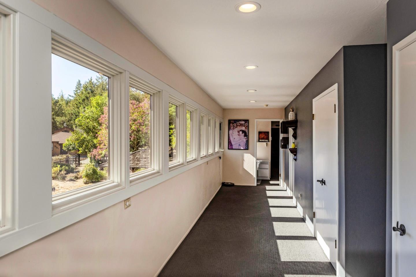 25255 Apple Hill Road Los Gatos, CA 95033 - Photo 12 of 47 a view of a hallway with wooden floor and windows