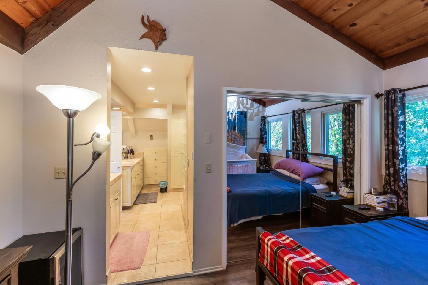 25255 Apple Hill Road Los Gatos, CA 95033 - Photo 15 of 47 a bedroom with a bed and wooden floor
