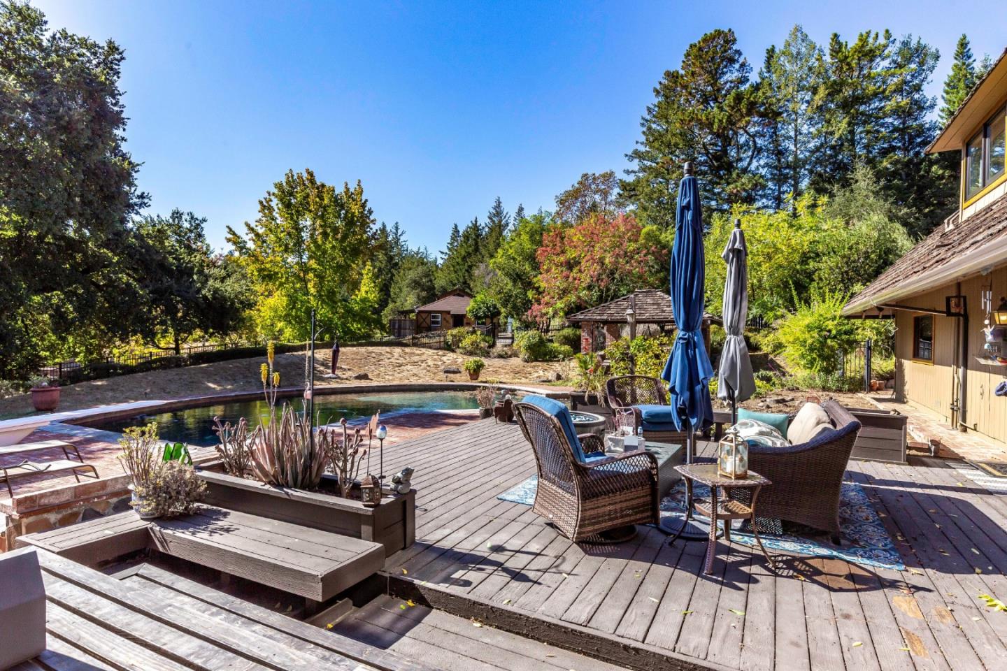 25255 Apple Hill Road Los Gatos, CA 95033 - Photo 25 of 47 a view of deck with table and chairs couches and a barbeque
