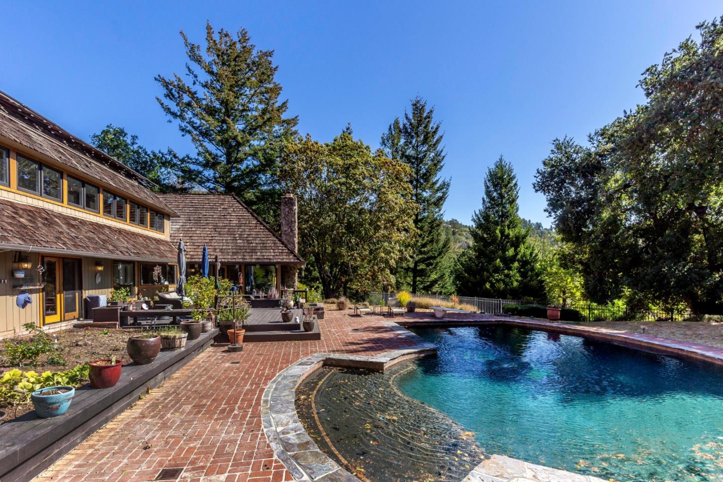 25255 Apple Hill Road Los Gatos, CA 95033 - Photo 30 of 47 a view of swimming pool with outdoor seating and trees in the background