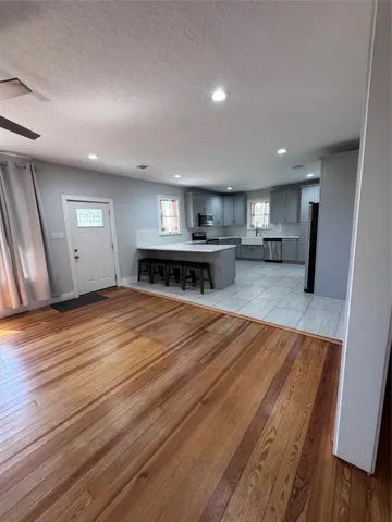 a view of a kitchen with microwave and cabinets