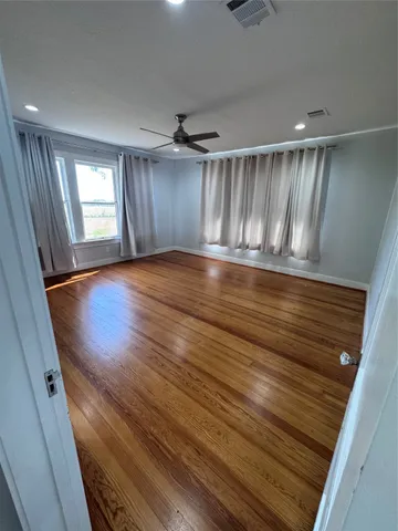 a large kitchen with a sink stainless steel appliances and cabinets