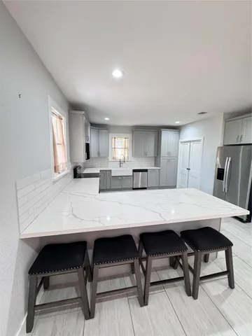 a view of kitchen cabinets and wooden floor