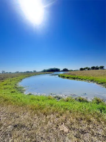 a view of a lake with houses in the back