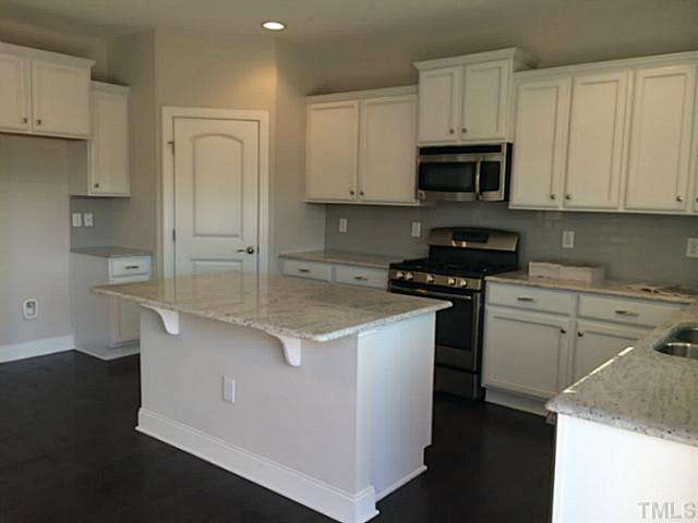 7517 Channery Way, Unit LT34 Raleigh, NC 27616 - Photo 15 of 25 a kitchen with stainless steel appliances granite countertop a sink a stove and a refrigerator
