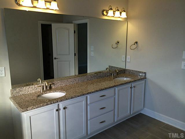 7517 Channery Way, Unit LT34 Raleigh, NC 27616 - Photo 21 of 25 a bathroom with a granite countertop sink and a mirror
