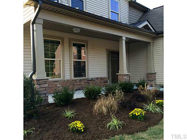 7517 Channery Way, Unit LT34 Raleigh, NC 27616 - Photo 8 of 25 a front view of a house with lots of flower around