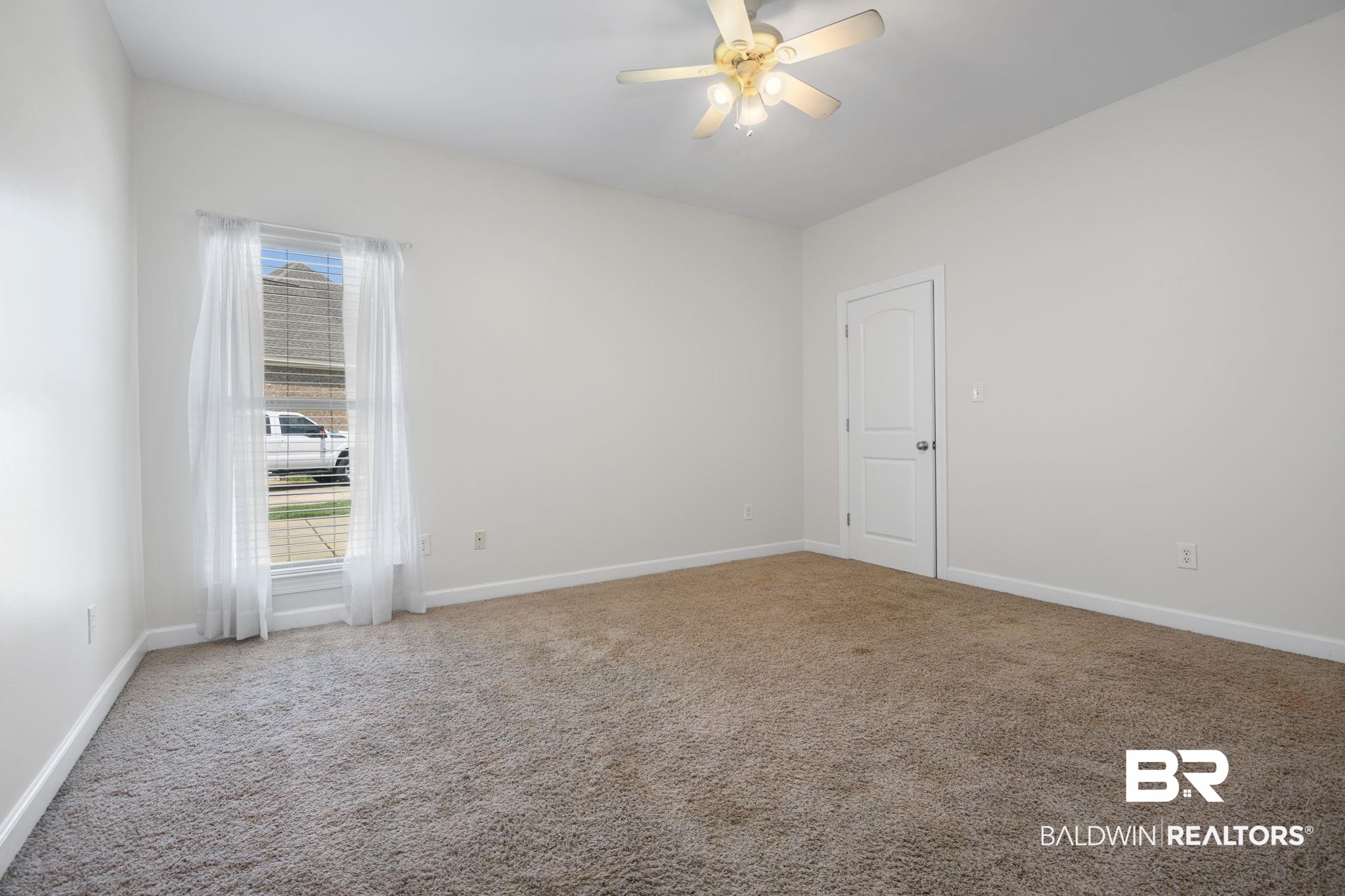 9730 Harmony Ridge Circle West Semmes, AL 36575 - Photo 27 of 38 Carpeted spare room with a ceiling fan and baseboards