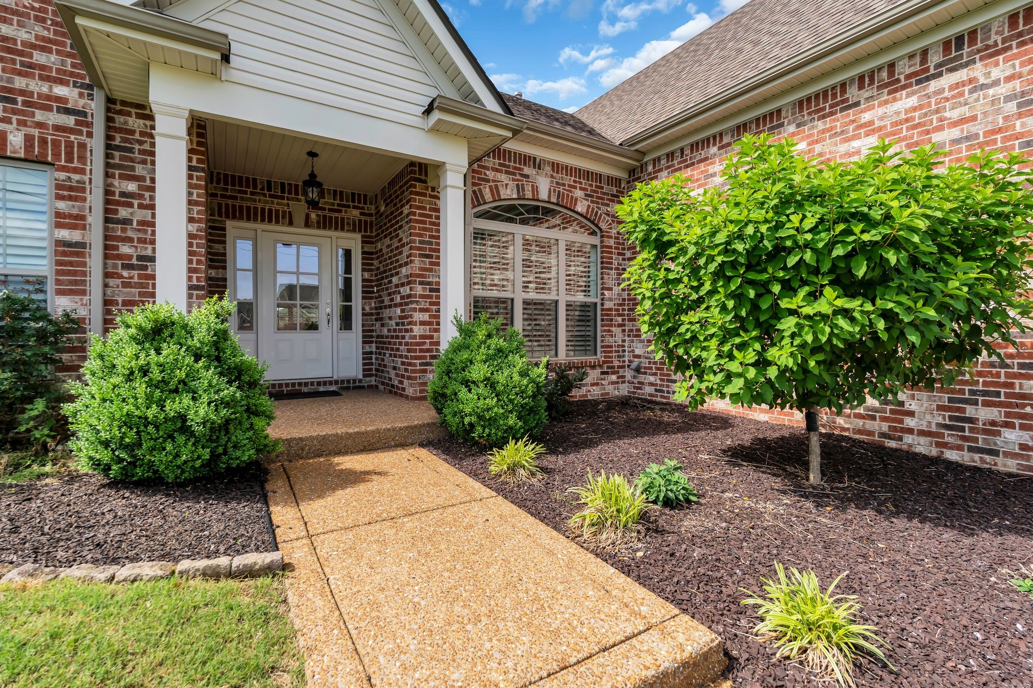 1103 Millstone Creek Road Lascassas, TN 37085 - Photo 3 of 38 a front view of a house with a garden