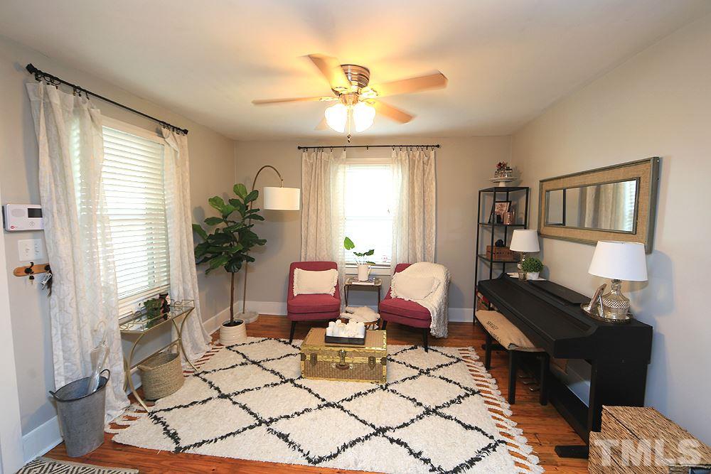 1530 Carson Street Raleigh, NC 27608 - Photo 3 of 21 The family room features hardwood floors, ceiling fan and vinyl windows.
