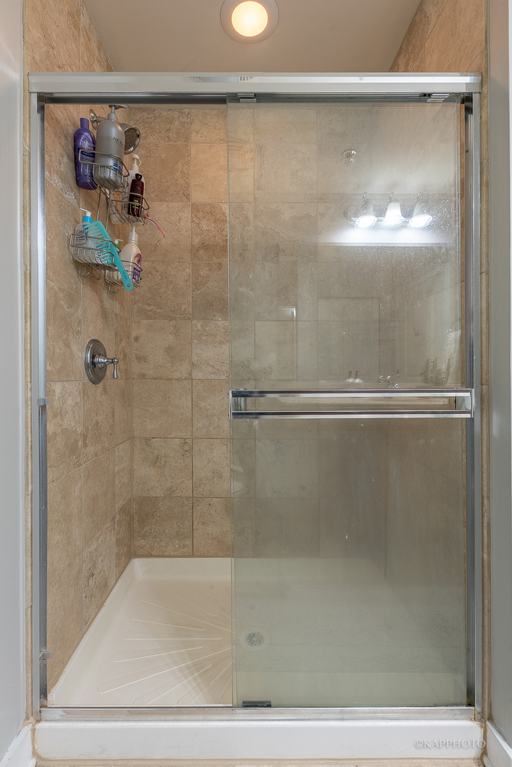 901 West Madison Street, Unit 512 Chicago, IL 60607 - Photo 23 of 36 a bathroom with a glass shower door