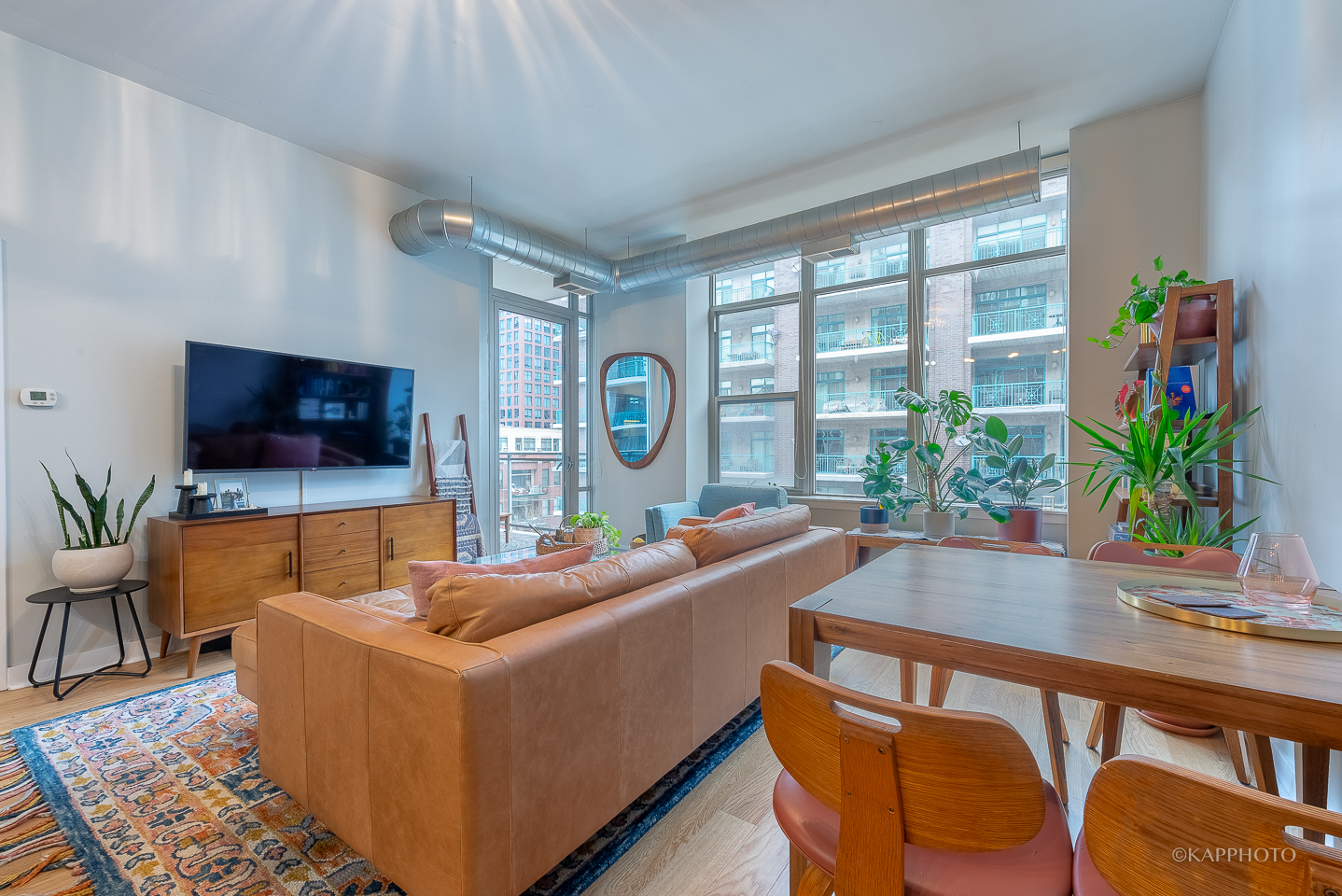 901 West Madison Street, Unit 512 Chicago, IL 60607 - Photo 8 of 36 a living room with furniture and a flat screen tv