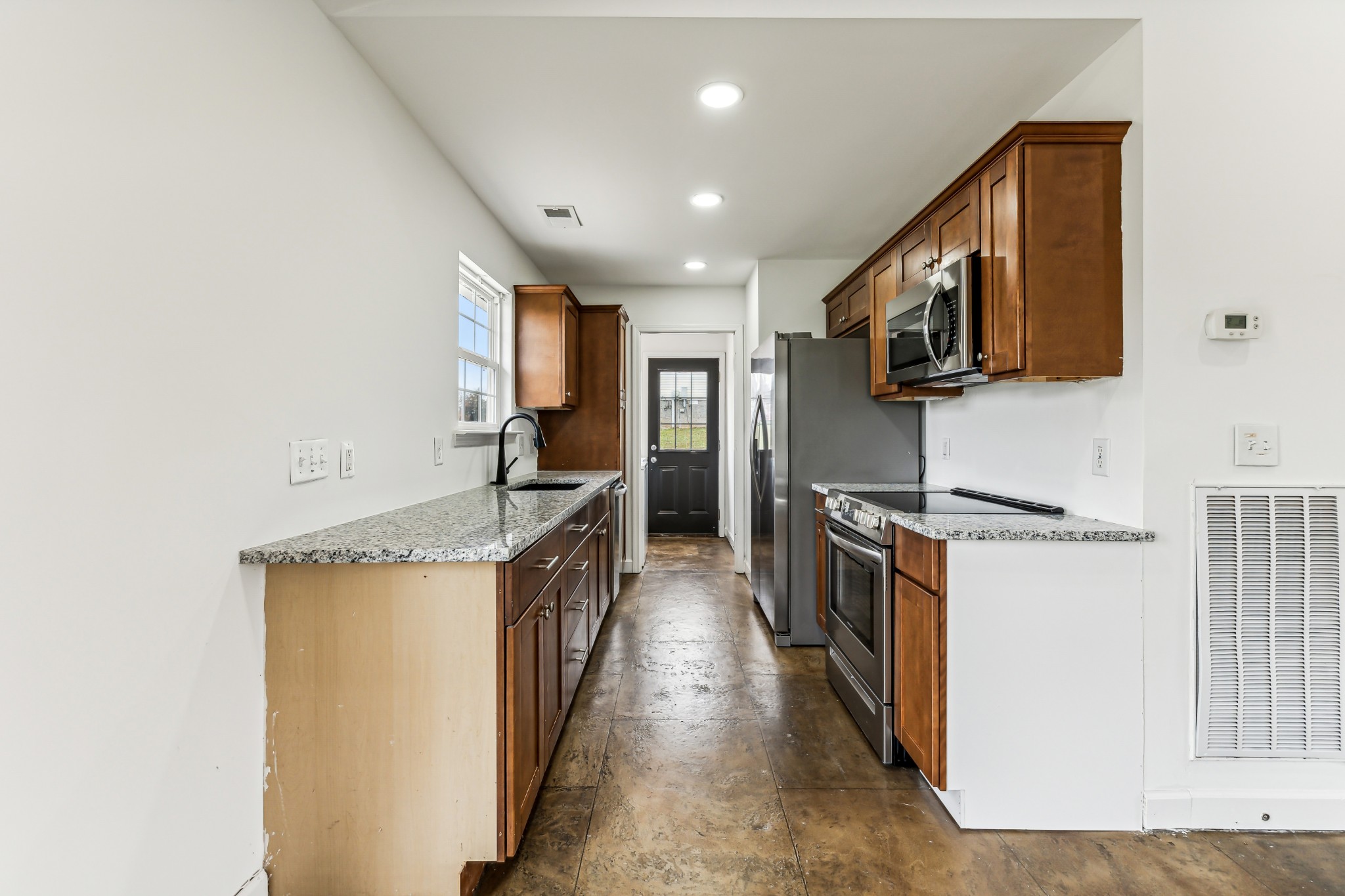 3772 Beasleys Bend Road Lebanon, TN 37087 - Photo 9 of 25 a kitchen with stainless steel appliances granite countertop a stove a sink and a refrigerator