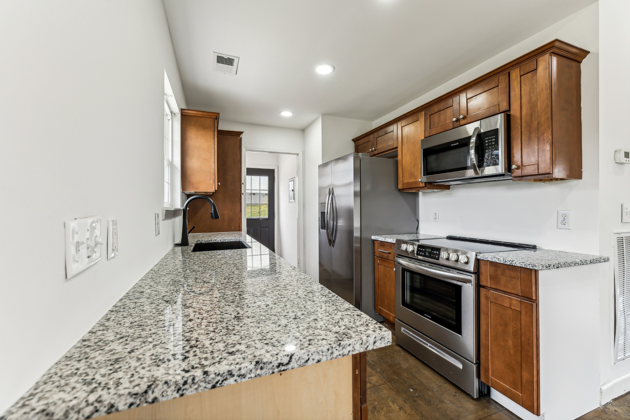 3772 Beasleys Bend Road Lebanon, TN 37087 - Photo 10 of 25 a kitchen with stainless steel appliances granite countertop a stove a microwave and a refrigerator