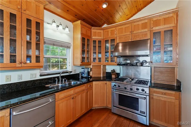a kitchen with stainless steel appliances a stove and a sink