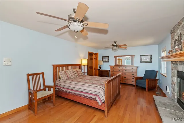 a bedroom with a bed couch and a chandelier