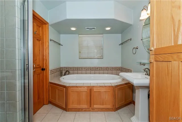 a bathroom with a tub and shower