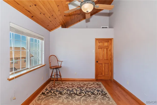a view of a livingroom with wooden floor and a window