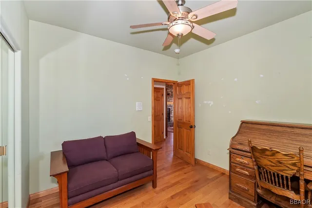 a living room with furniture and a ceiling fan