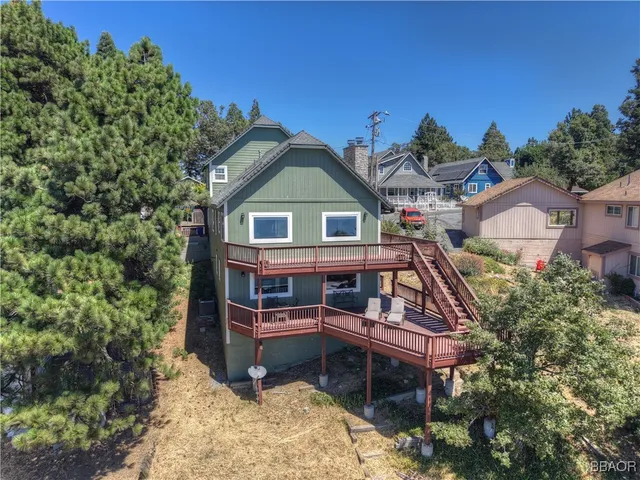 a aerial view of a house with a yard balcony and sitting area