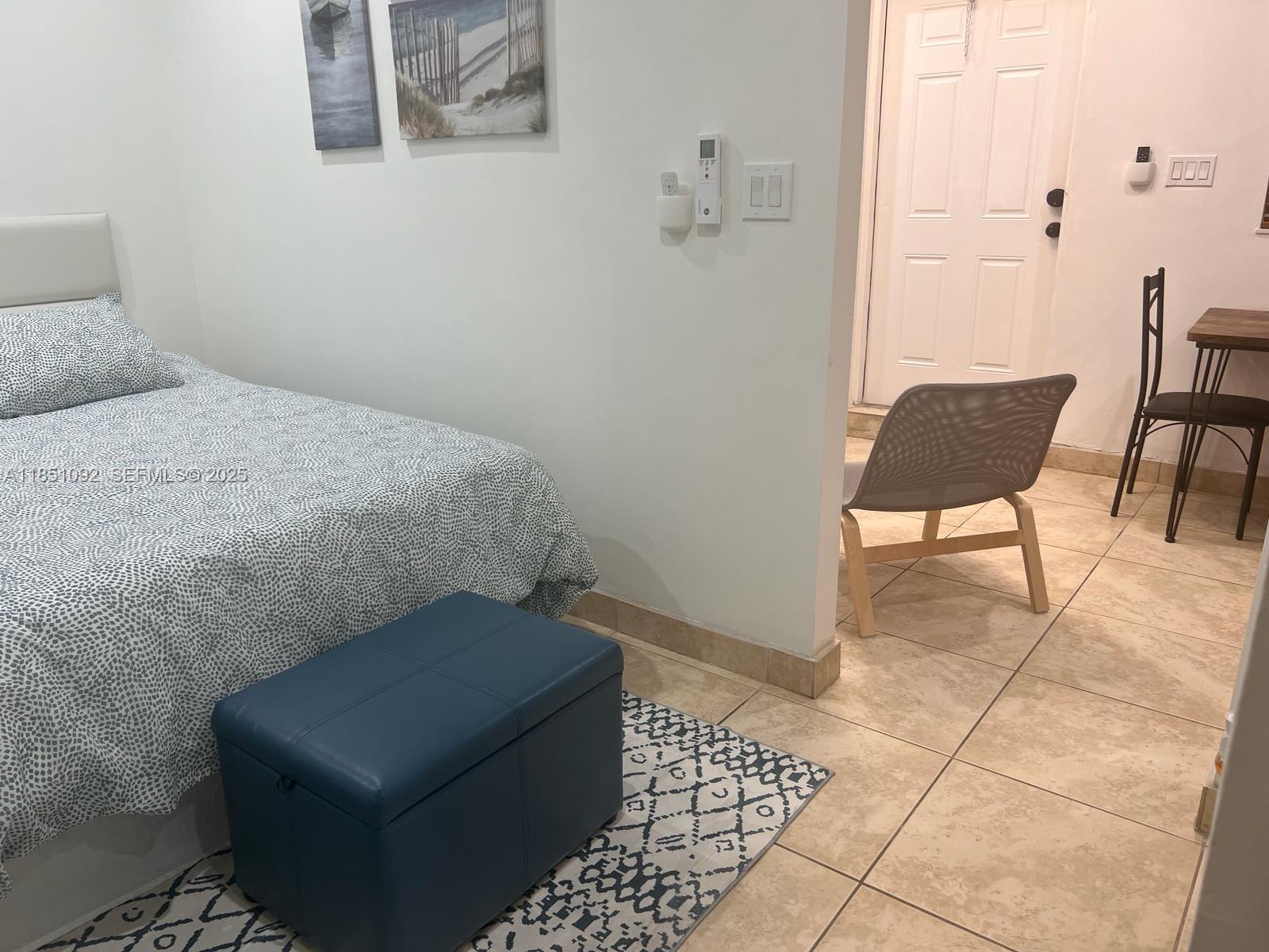 1721 Southwest 24th Terrace Miami, FL 33145 - Photo 65 of 80 a bedroom with a chair and potted plant on a table