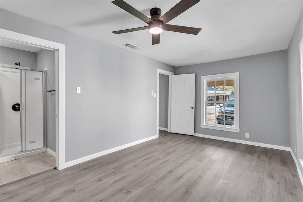 904 North Virginia Street Terrell, TX 75160 - Photo 11 of 22 a view of an empty room with wooden floor and a window