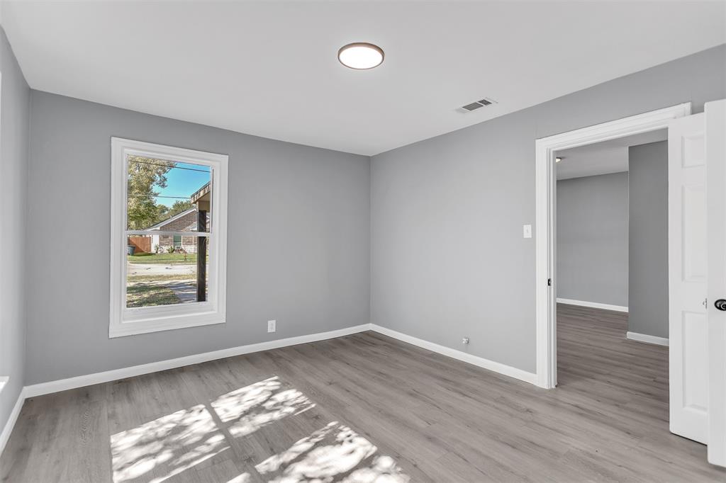 904 North Virginia Street Terrell, TX 75160 - Photo 13 of 22 an empty room with wooden floor and windows