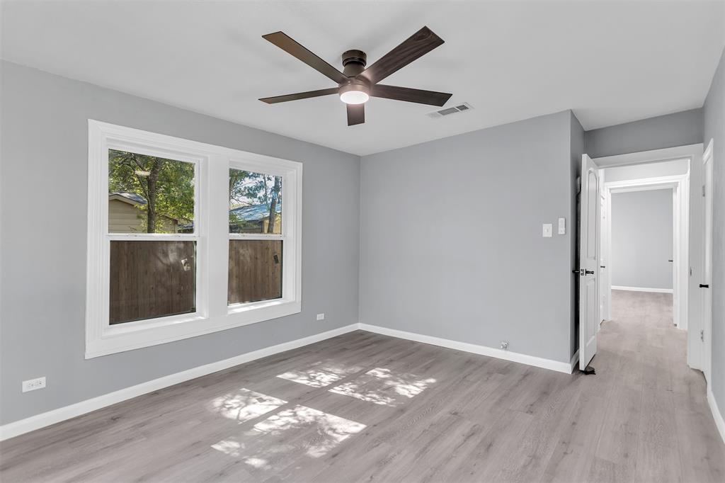 904 North Virginia Street Terrell, TX 75160 - Photo 16 of 22 a view of an empty room with a window and wooden floor