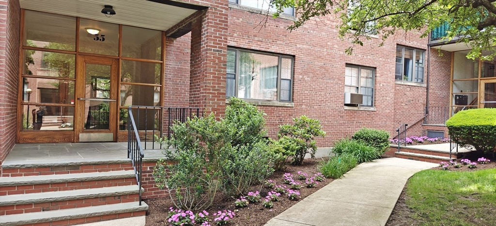55 Harvard Avenue, Unit 6 Brookline, MA 02446 - Photo 1 of 1 a front view of a house having yard