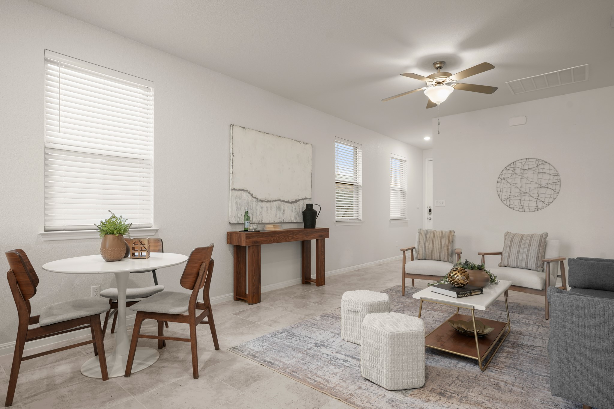 152 Mountain Valley Street Georgetown, TX 78628 - Photo 6 of 38 An open living space features durable tile flooring and abundant natural light from multiple windows.