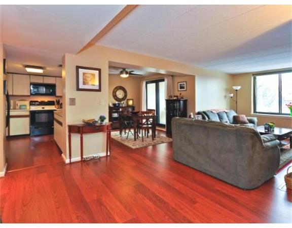 85 Brainerd Road, Unit 313 Boston, MA 02134 - Photo 2 of 5 a living room with furniture and a wooden floor