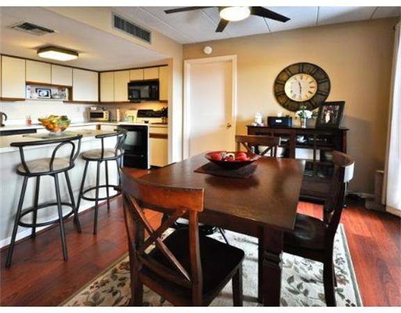 85 Brainerd Road, Unit 313 Boston, MA 02134 - Photo 4 of 5 a view of a dining room with furniture and wooden floor