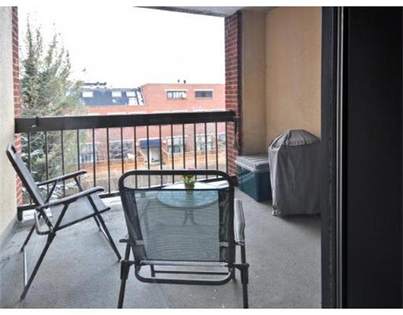 85 Brainerd Road, Unit 313 Boston, MA 02134 - Photo 5 of 5 a view of a chairs and table in a balcony
