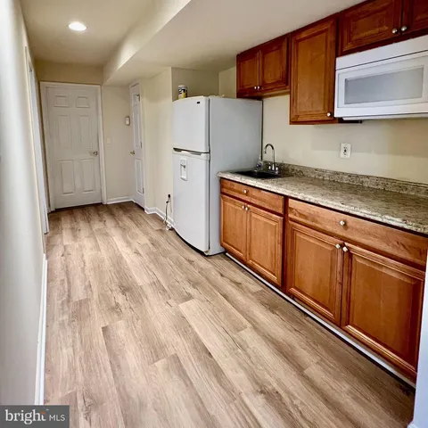 a kitchen with granite countertop cabinets stainless steel appliances and sink